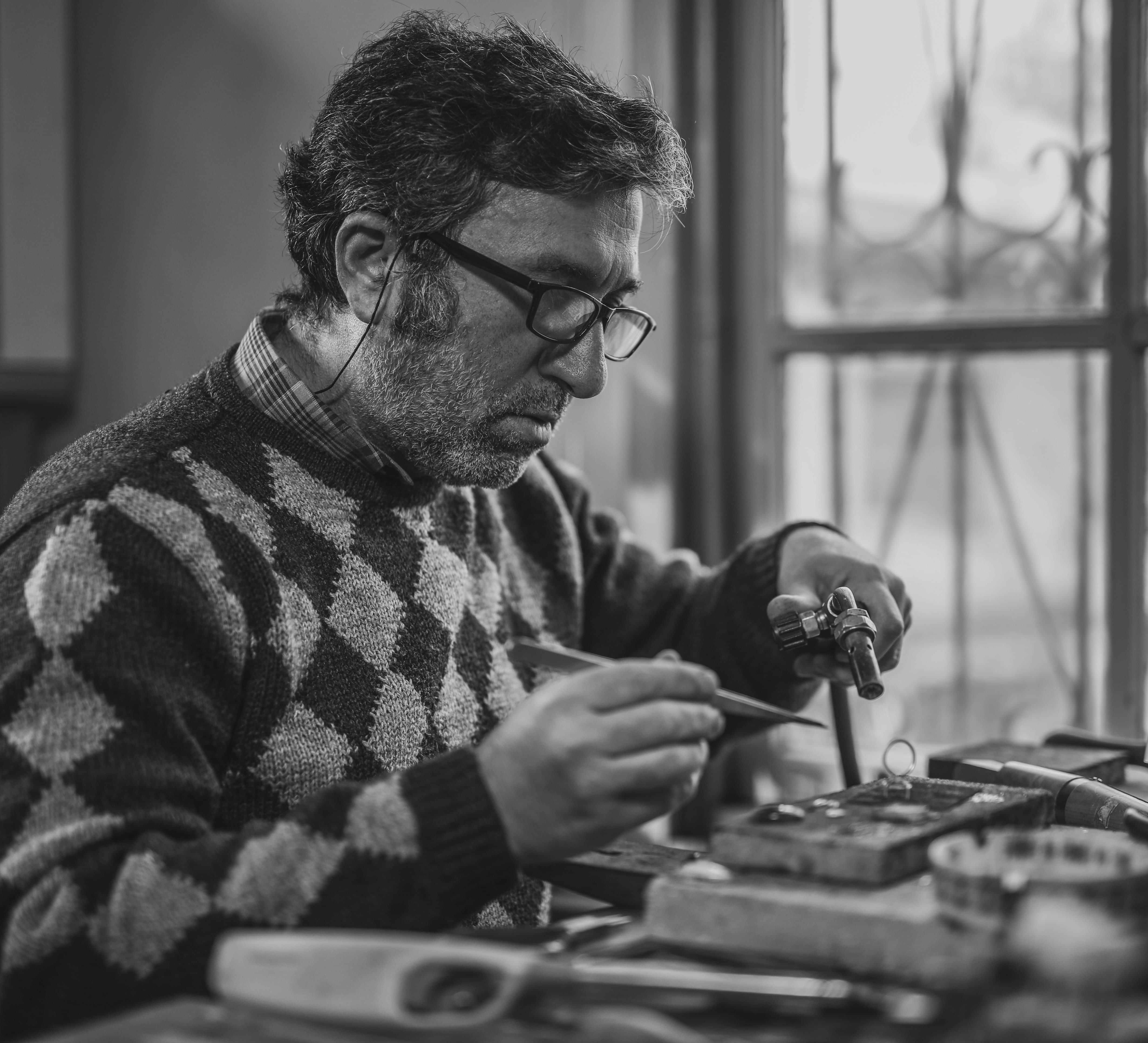 Old Man with glasses crafting equipment